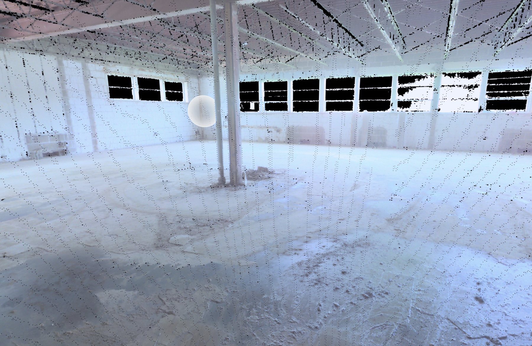 Laser scan point cloud of an empty industrial interior — bare block walls, clerestory windows, steel columns and open roof structure rendered in scan points.